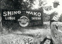 guy with hat by sign 1940's